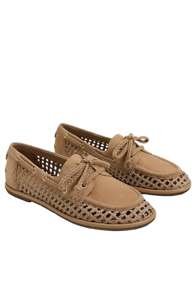 Pair of tan shoes with perforated design on a white background