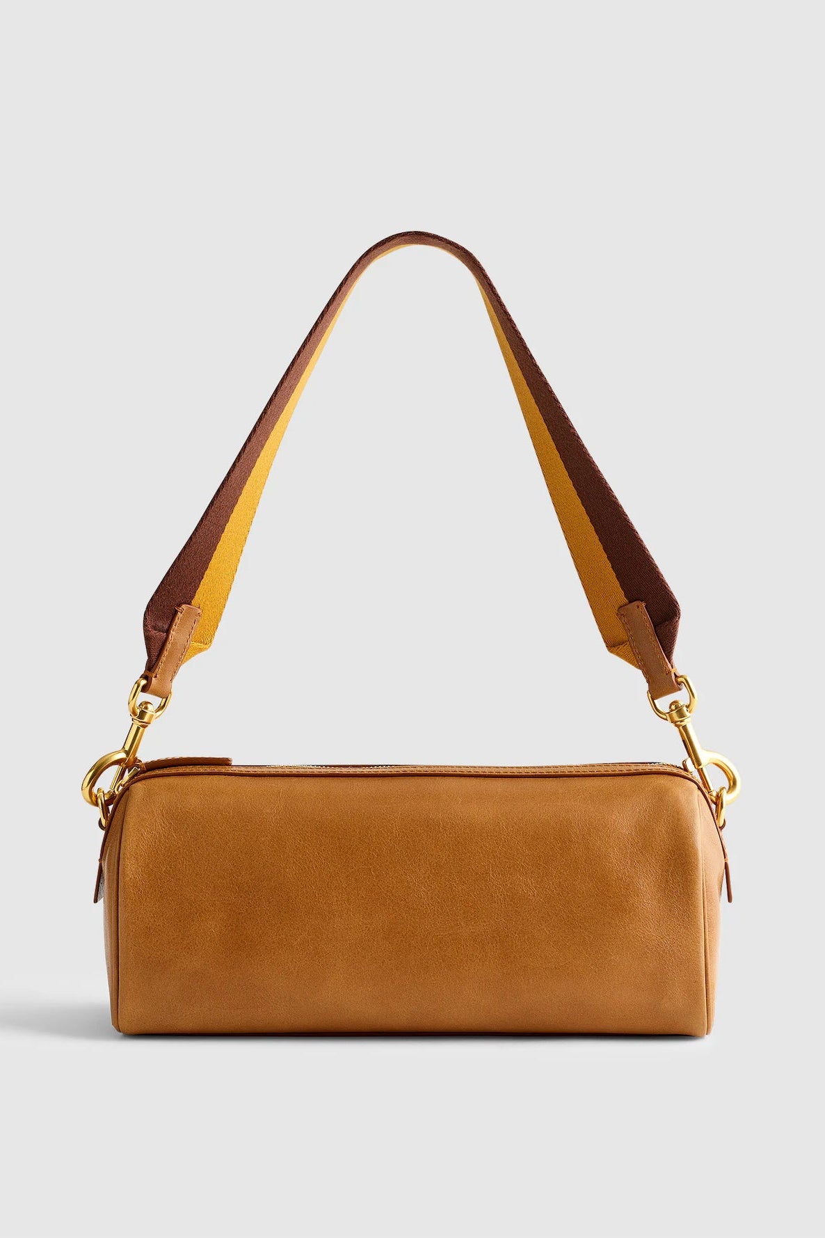 A tan leather shoulder bag with a matching top zipper, gold-tone hardware, and a dual-tone brown and tan shoulder strap, shown against a light gray background.