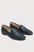 A pair of navy blue woven leather loafers with a silver horsebit detail on the vamp, displayed on a clean white background.