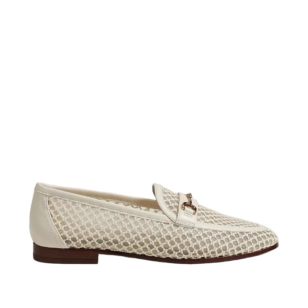 A single cream-colored slip-on loafer featuring a textured honeycomb pattern on the sides and a small gold-tone horsebit detail on the vamp, shown against a plain light gray background.