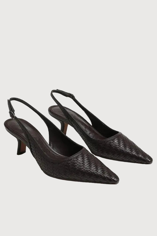 A pair of dark brown woven leather slingback pumps with pointed toes and kitten heels, displayed on a light gray background.